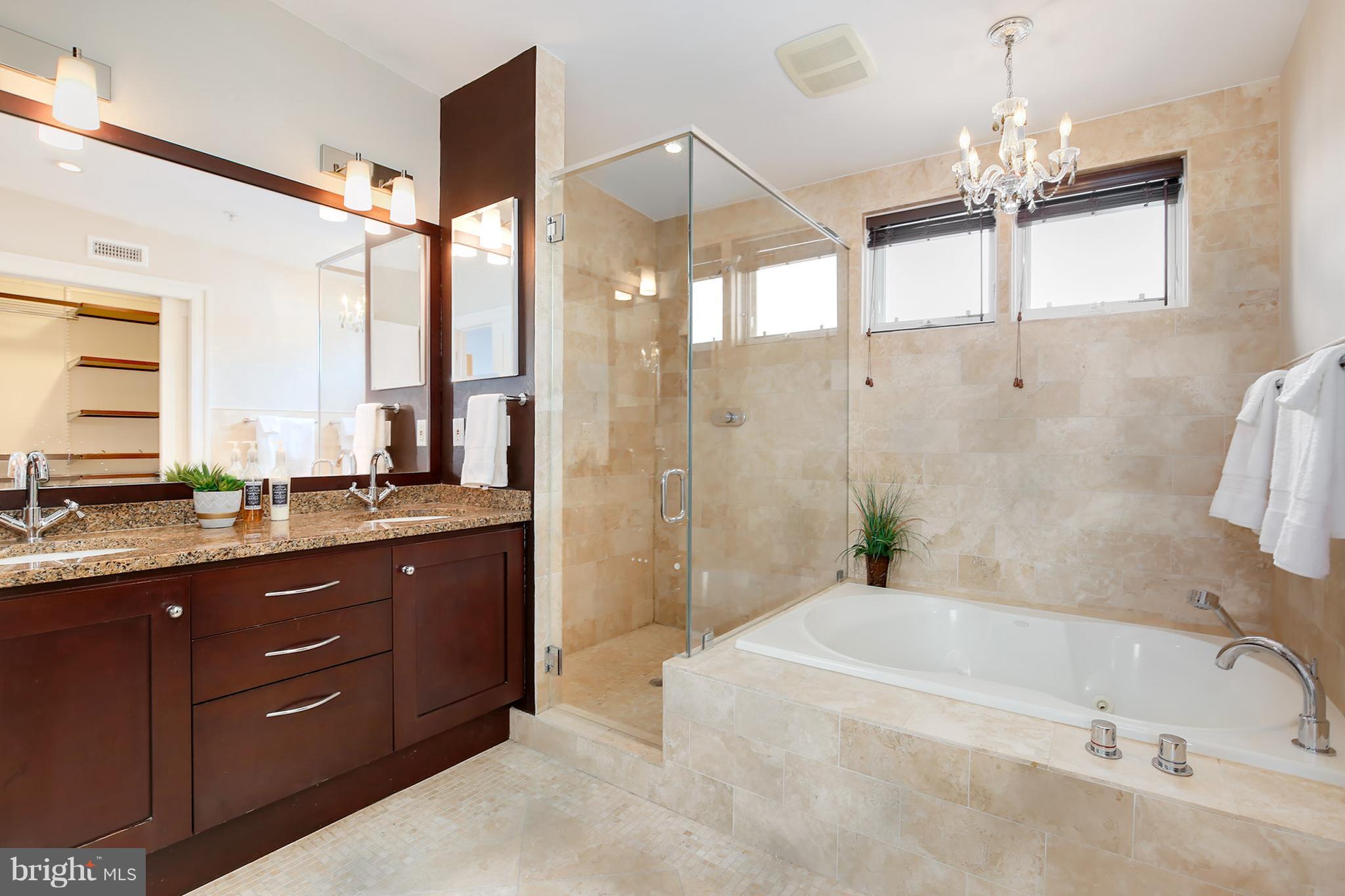 1433 R Street Northwest, Unit 4 Washington, DC 20009 - Photo 22 of 27 a bathroom with a tub sink and mirror