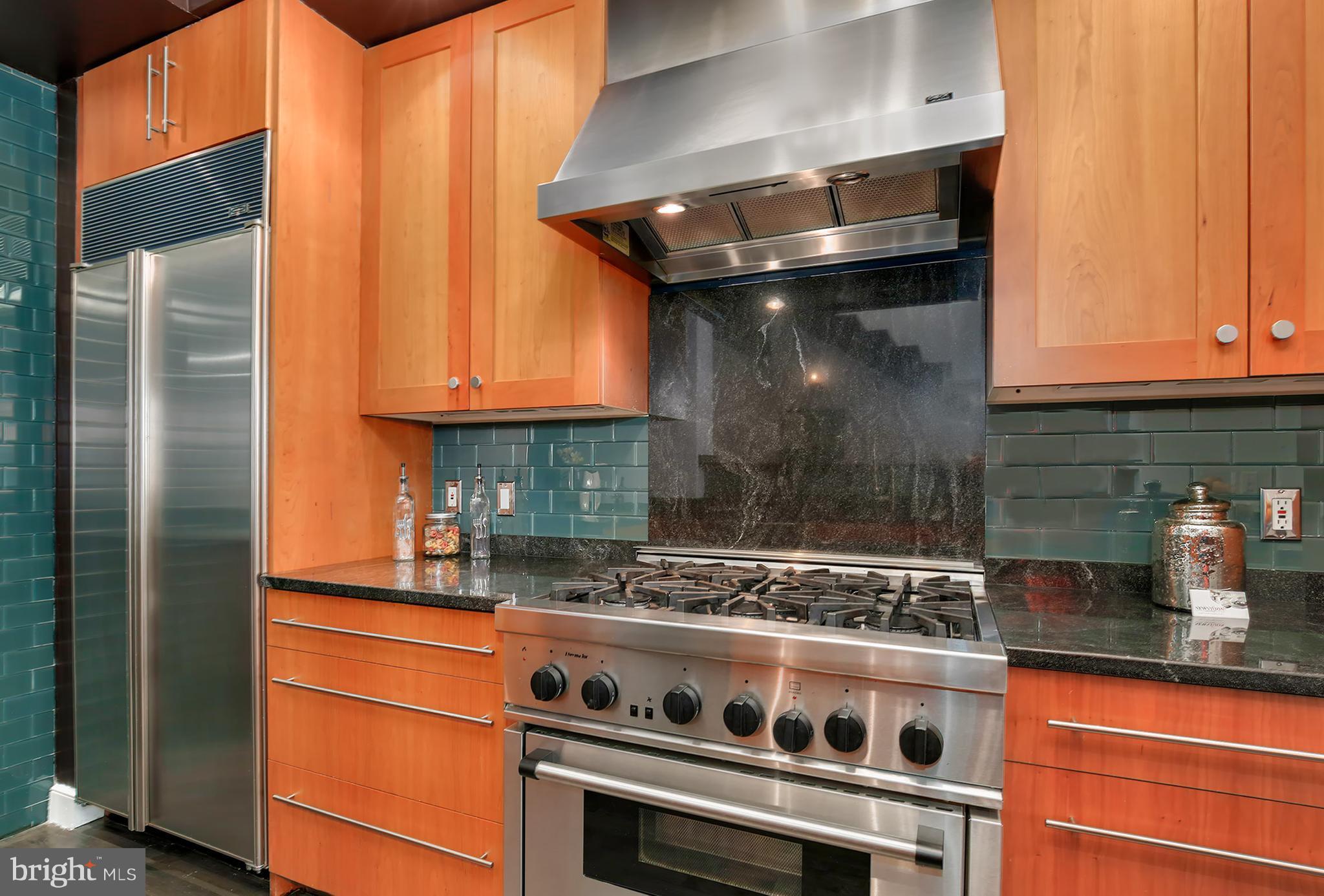 1433 R Street Northwest, Unit 4 Washington, DC 20009 - Photo 8 of 27 a kitchen with stainless steel appliances granite countertop a stove and a refrigerator