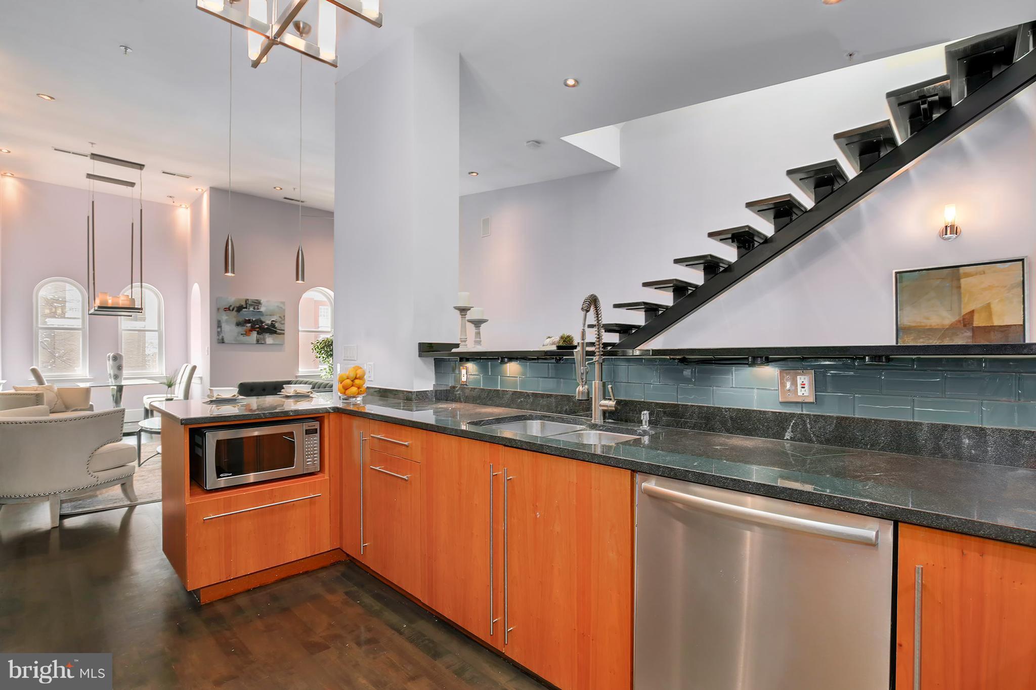 1433 R Street Northwest, Unit 4 Washington, DC 20009 - Photo 9 of 27 a kitchen with stainless steel appliances granite countertop a sink a stove and a wooden floors