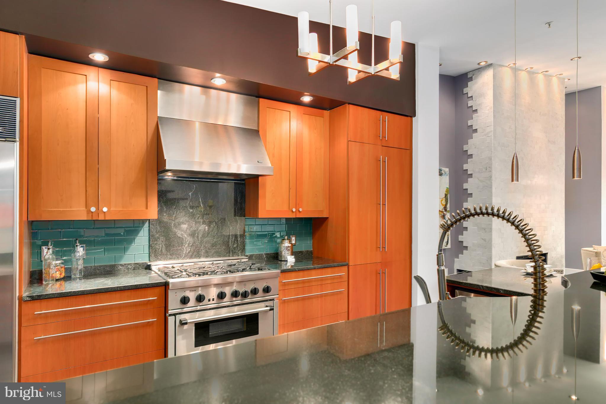 1433 R Street Northwest, Unit 4 Washington, DC 20009 - Photo 10 of 27 a kitchen with stainless steel appliances granite countertop a stove a sink and a refrigerator