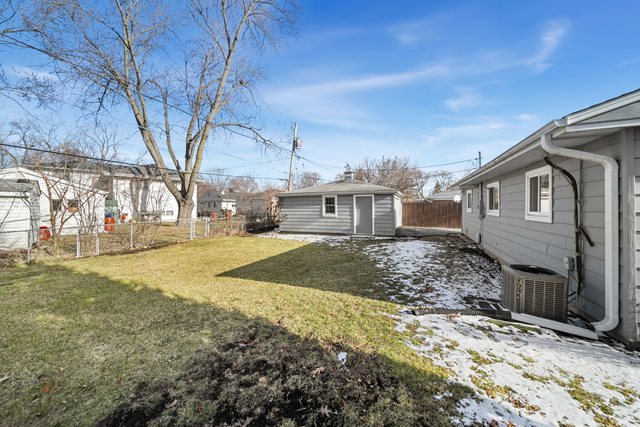 712 South Wayne Place Wheeling, IL 60090 - Photo 19 of 22 a front view of a house with a yard