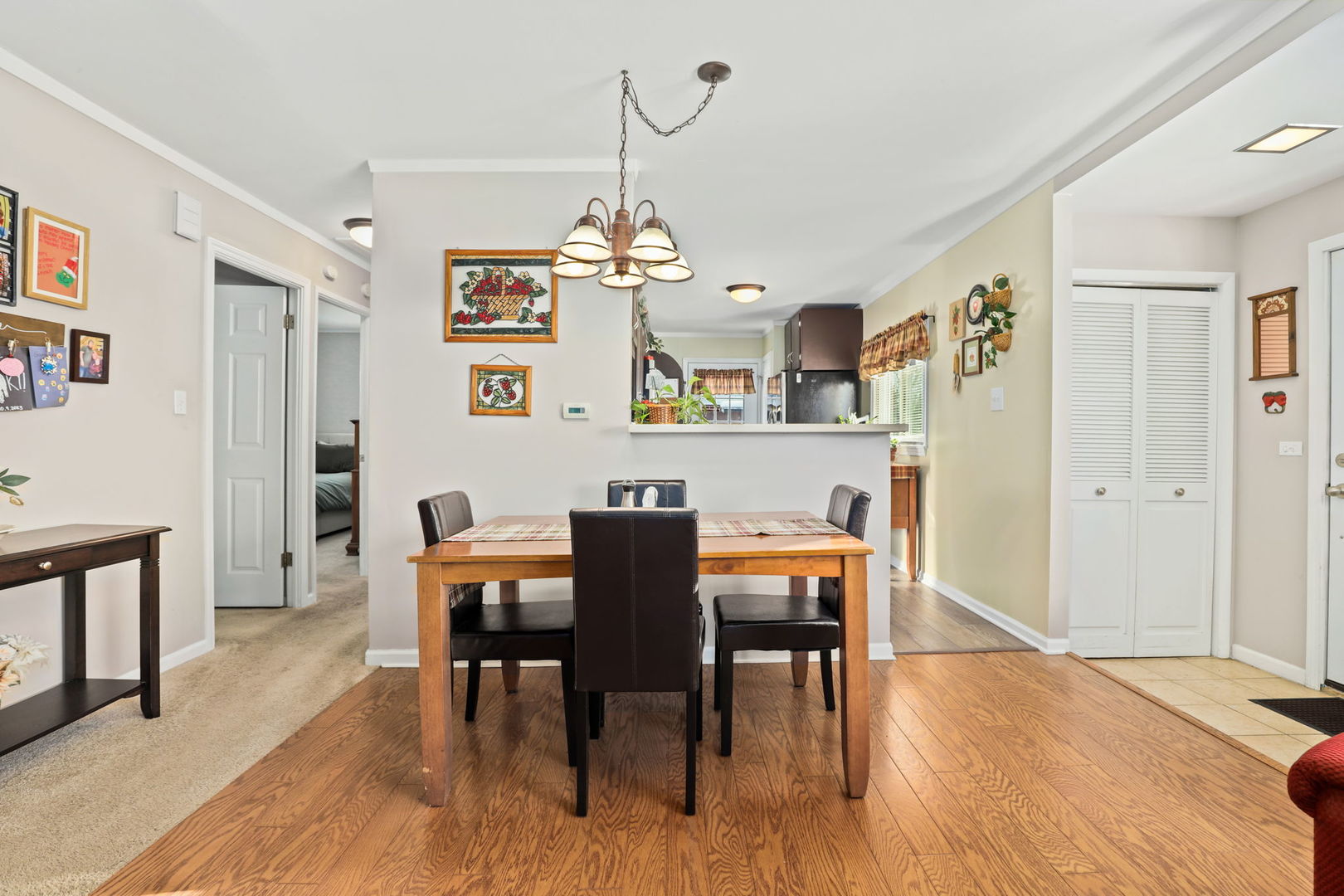 712 South Wayne Place Wheeling, IL 60090 - Photo 4 of 22 a view of a dining room with furniture and wooden floor