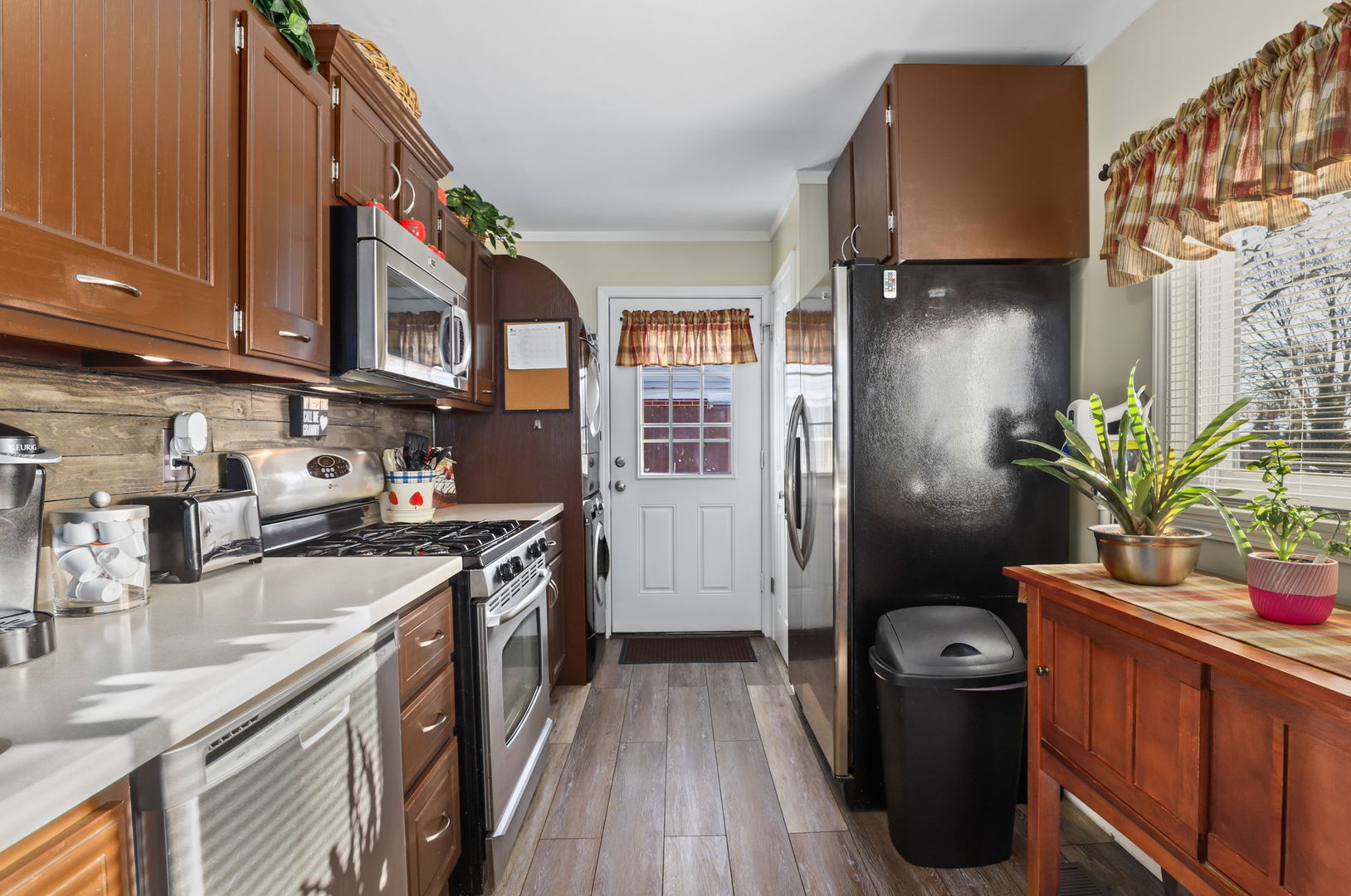 712 South Wayne Place Wheeling, IL 60090 - Photo 8 of 22 a kitchen with stainless steel appliances granite countertop a refrigerator a sink dishwasher a stove and a dining table with wooden floor