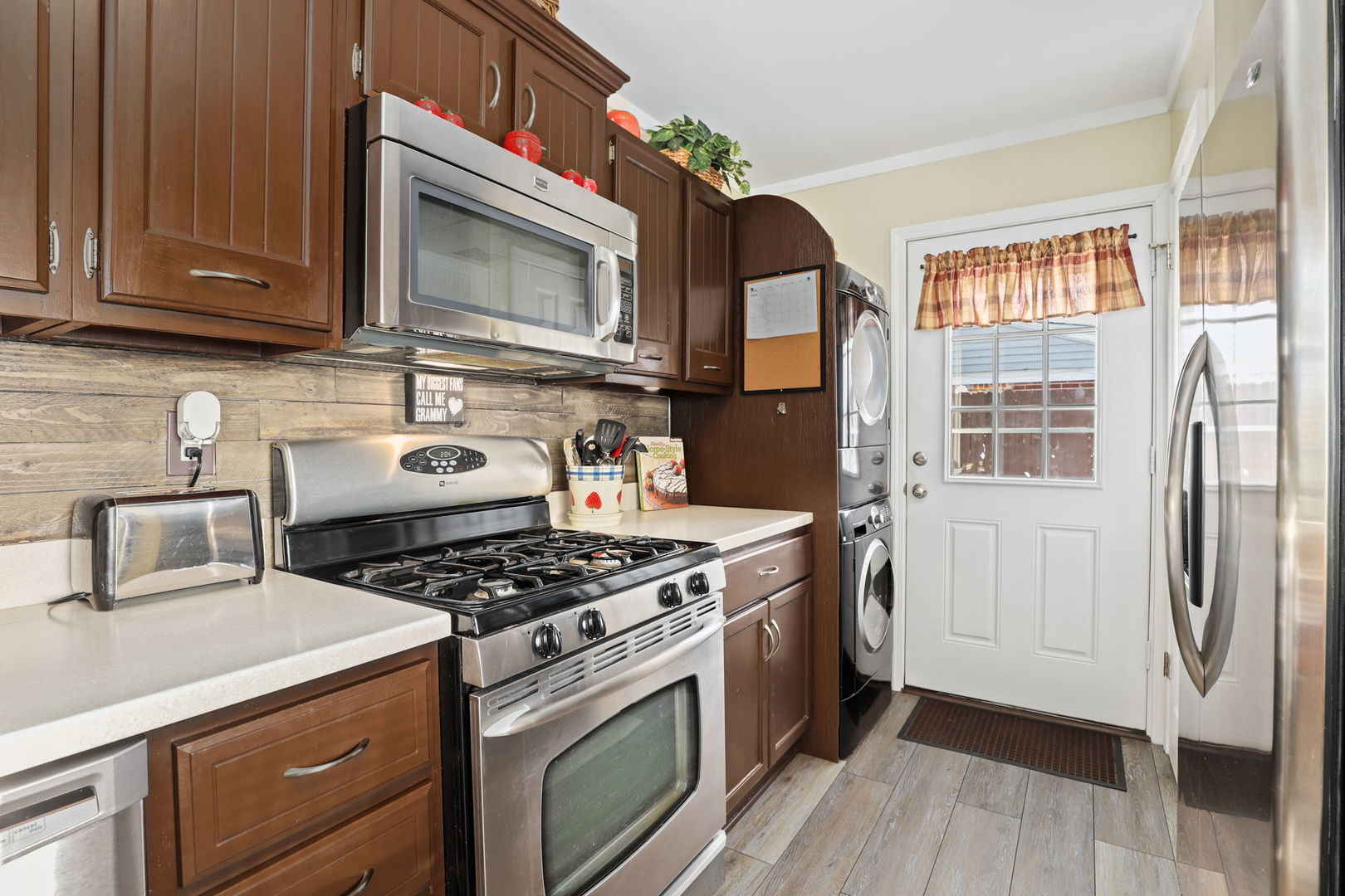 712 South Wayne Place Wheeling, IL 60090 - Photo 9 of 22 a kitchen with stainless steel appliances granite countertop a stove a microwave and a refrigerator