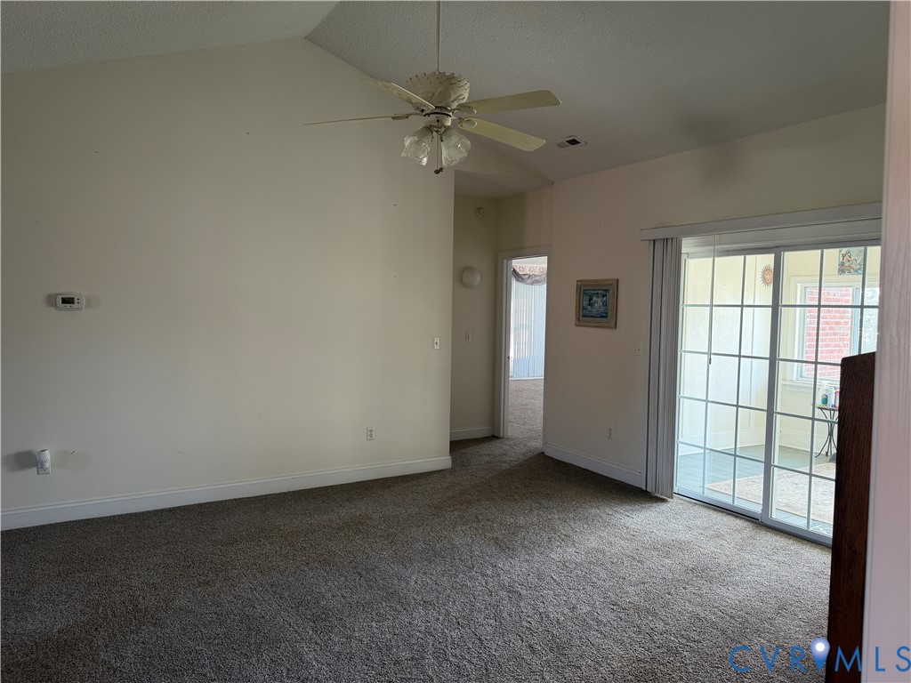 225 Lighthouse Pointe Hopewell, VA 23860 - Photo 20 of 23 an empty room with a ceiling fan and windows