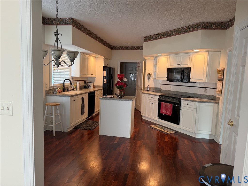 225 Lighthouse Pointe Hopewell, VA 23860 - Photo 21 of 23 a kitchen with a stove and a wooden floor
