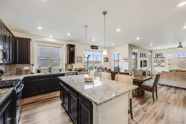 a kitchen with center island table and chairs in it