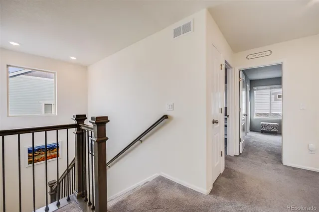 a view of a hallway with a livingroom and entryway