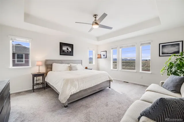 a spacious bedroom with a bed and a couch