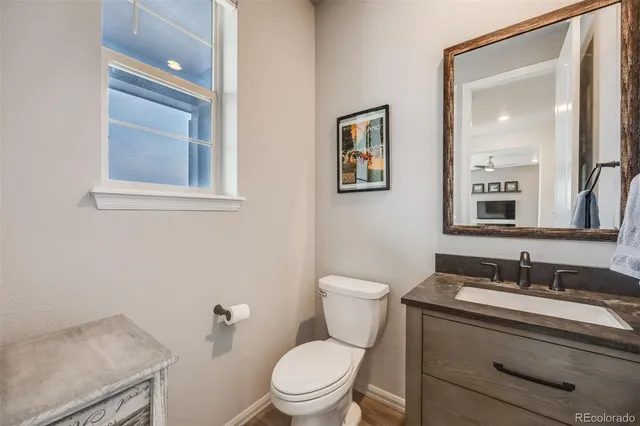 a bathroom with a toilet a sink and mirror