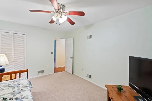 a bedroom with bed and flat screen tv