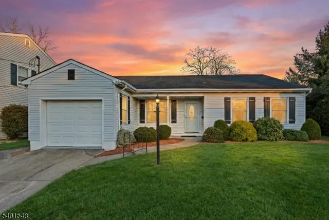 a front view of house with yard and outdoor seating