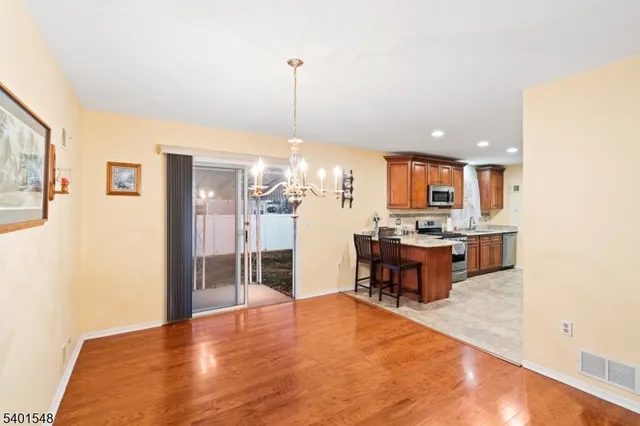 a large kitchen with a table and chairs