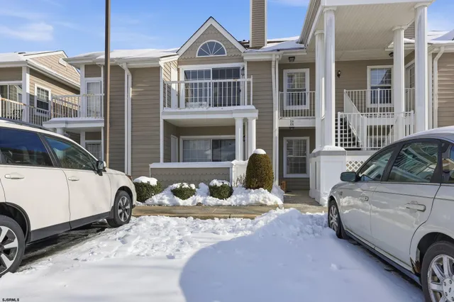 a front view of a house with parking space