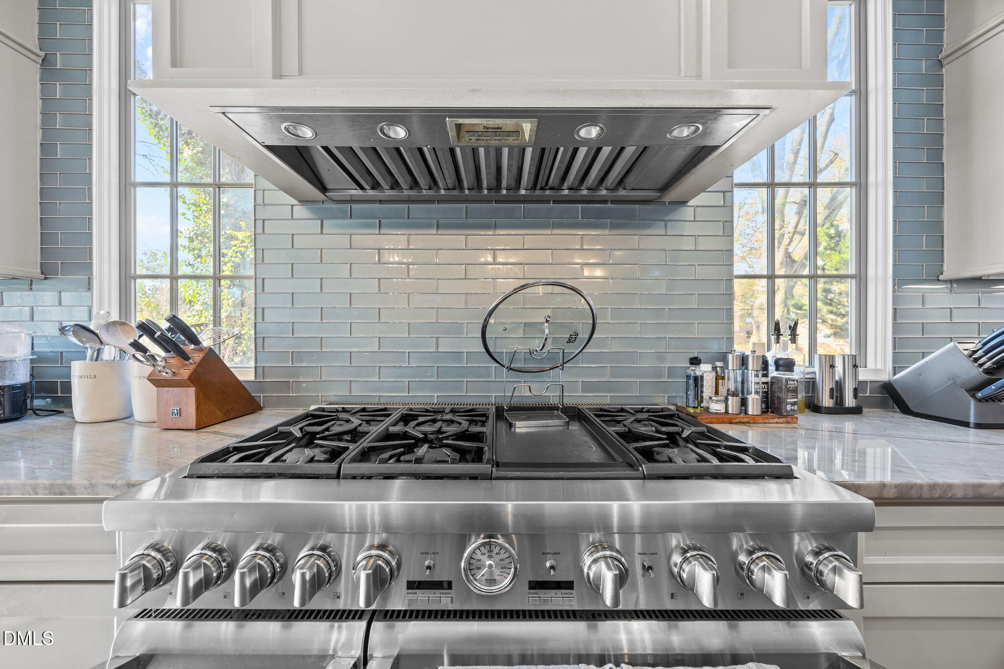 630 Daniels Street Raleigh, NC 27605 - Photo 12 of 34 a close view of a stove a sink and dishwasher with wooden floor