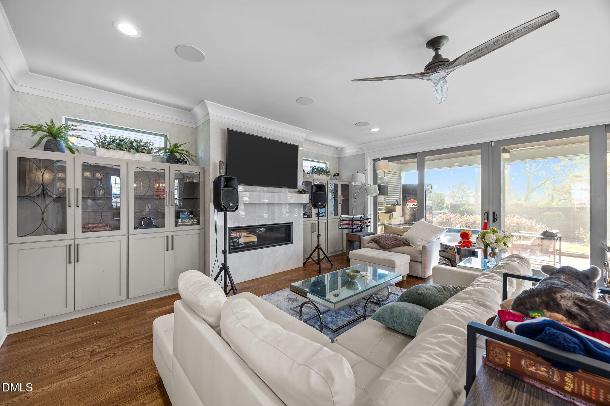 630 Daniels Street Raleigh, NC 27605 - Photo 13 of 34 a living room with furniture a flat screen tv and a floor to ceiling window