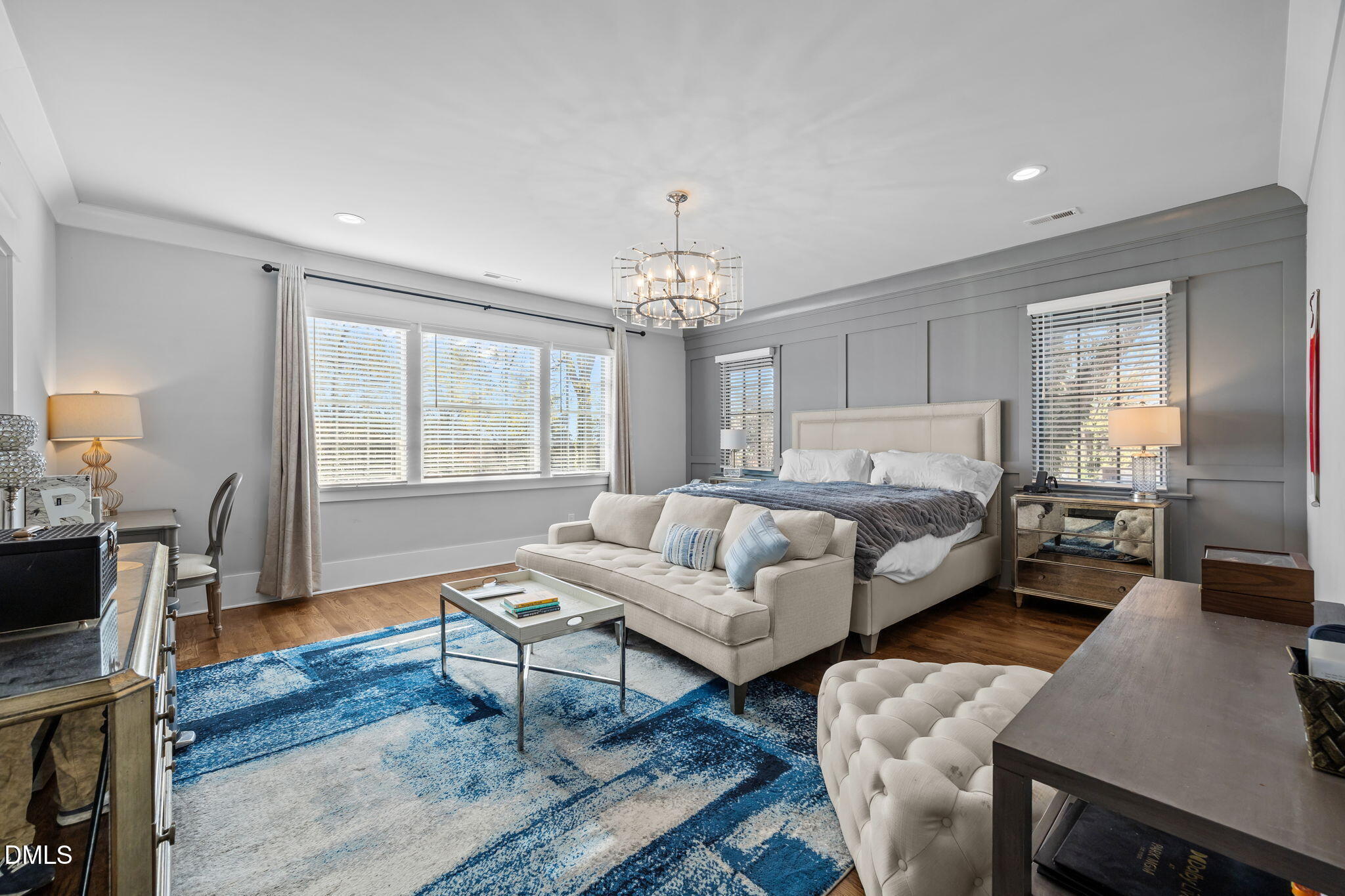 630 Daniels Street Raleigh, NC 27605 - Photo 17 of 34 a living room with furniture a dining table and a chandelier