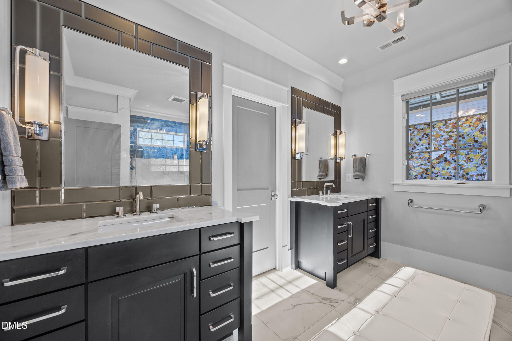 630 Daniels Street Raleigh, NC 27605 - Photo 19 of 34 a bathroom with a sink double vanity and a mirror