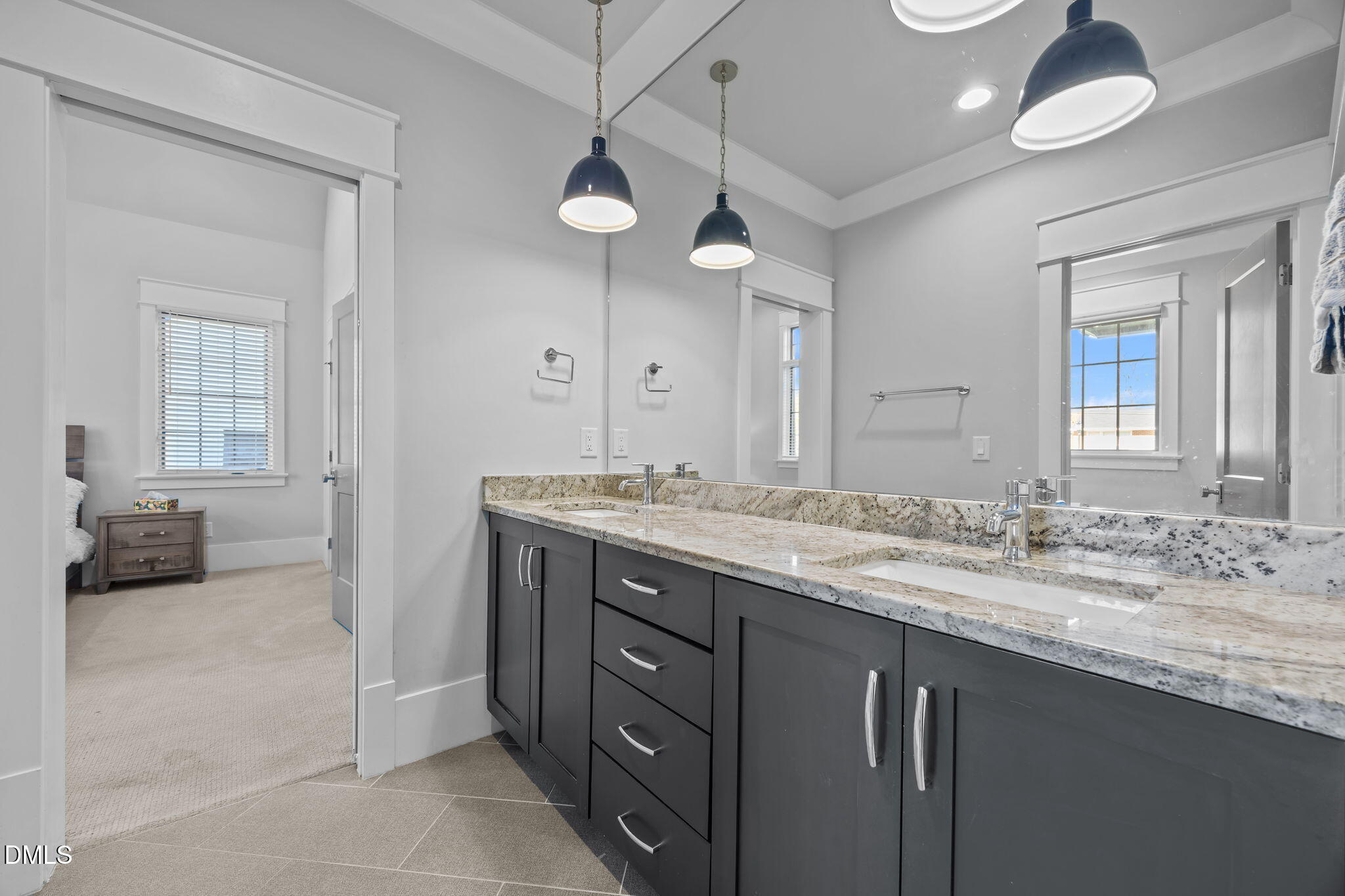 630 Daniels Street Raleigh, NC 27605 - Photo 26 of 34 a bathroom with a granite countertop sink and a mirror