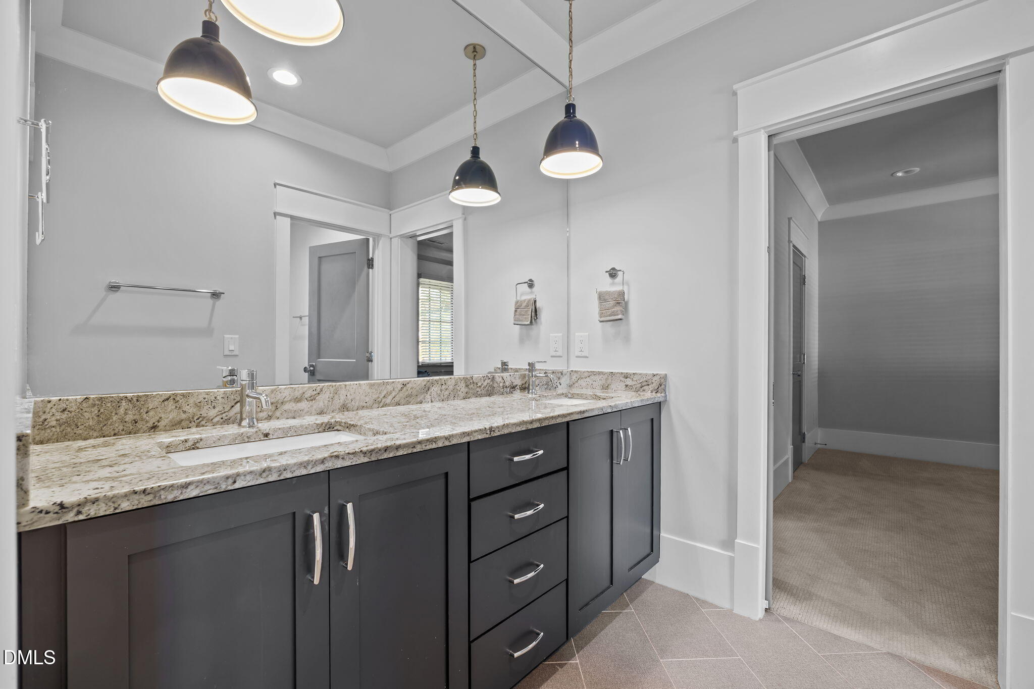 630 Daniels Street Raleigh, NC 27605 - Photo 27 of 34 a bathroom with a granite countertop sink a large mirror and a shower