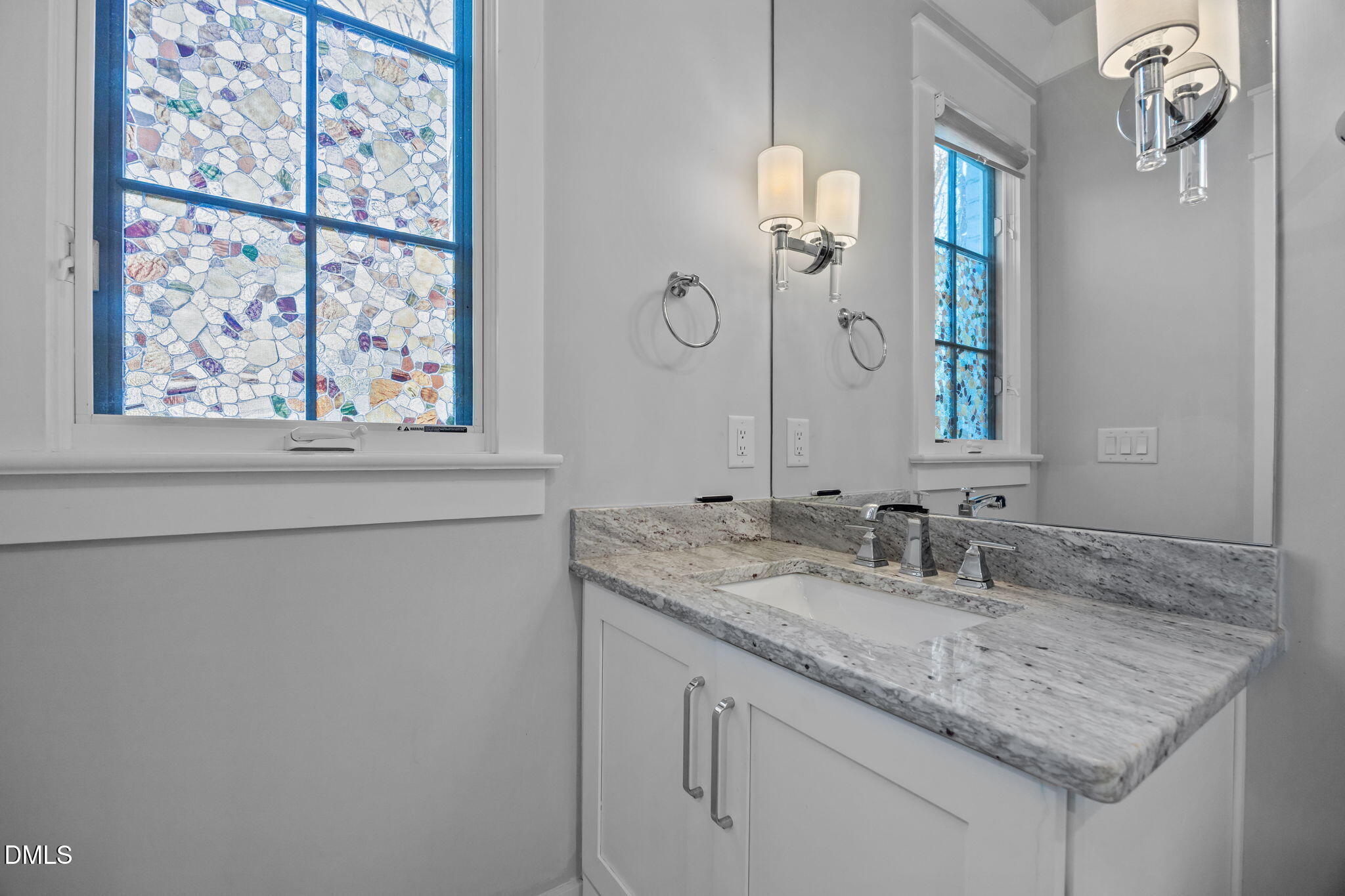 630 Daniels Street Raleigh, NC 27605 - Photo 29 of 34 a bathroom with a granite countertop sink a large mirror and a window