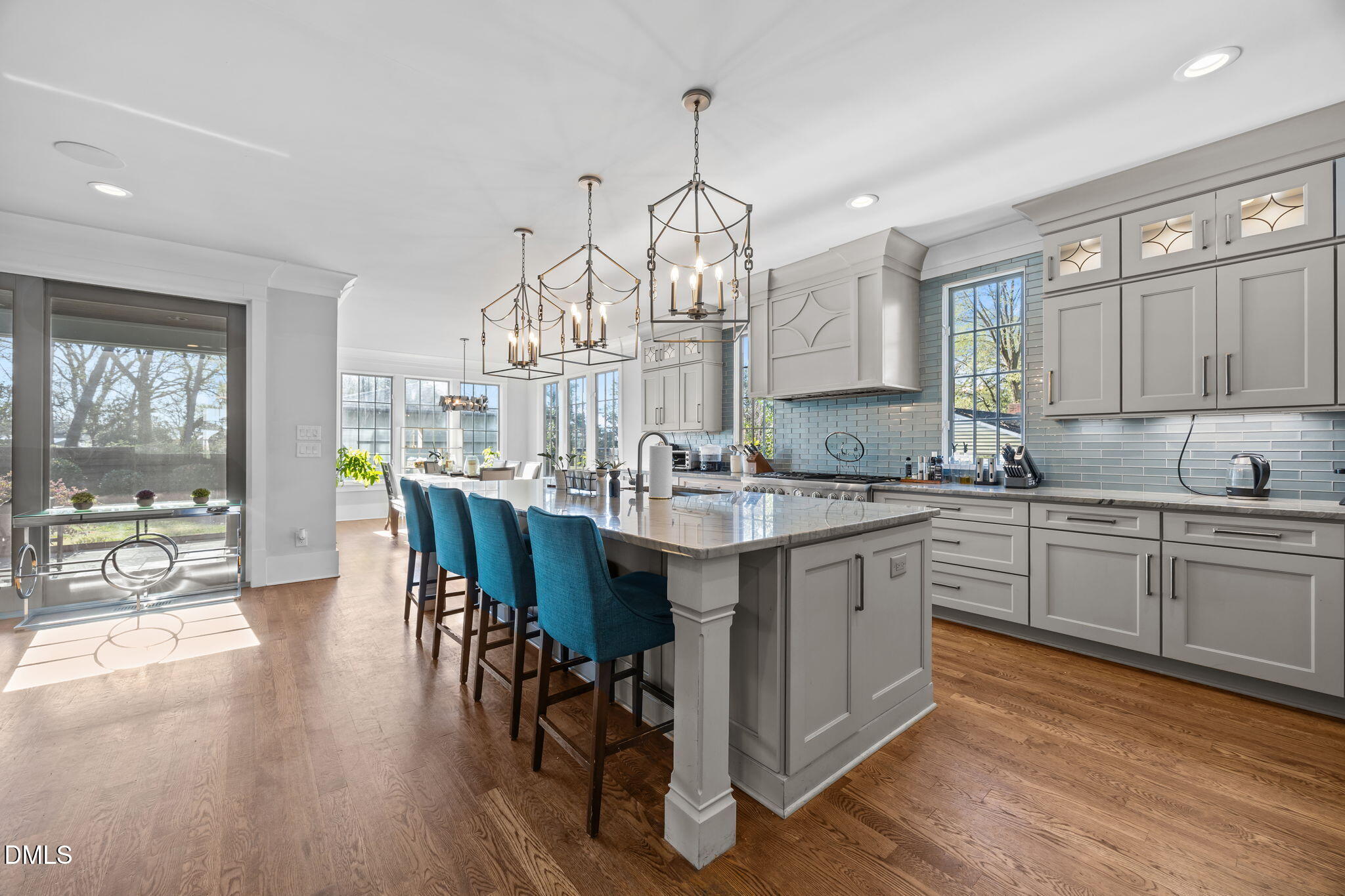630 Daniels Street Raleigh, NC 27605 - Photo 5 of 34 a kitchen with granite countertop a sink dishwasher a dining table and chairs with wooden floor