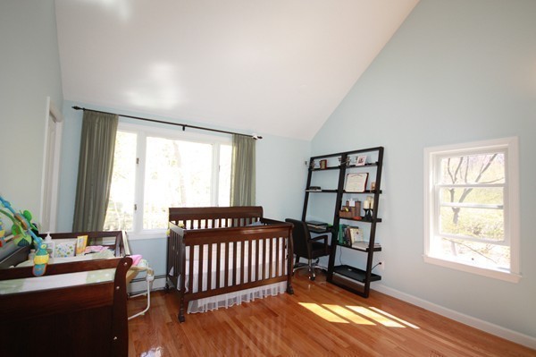 328 Quinobequin Road Newton, MA 02468 - Photo 12 of 22 a bedroom with a bed and a window