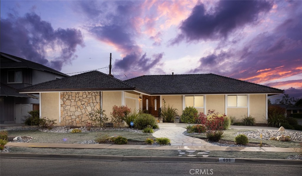 a view of a white house with a yard