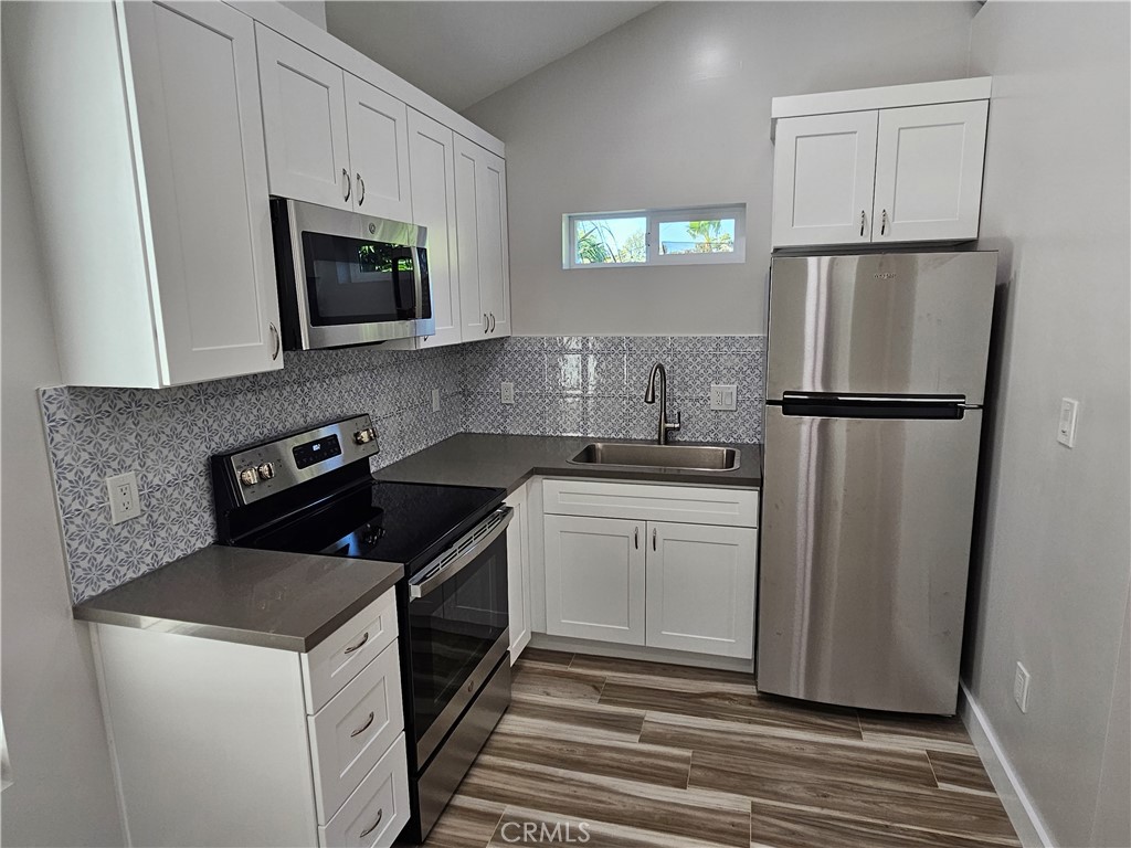 6570 Mt Diablo Avenue Riverside, CA 92506 - Photo 6 of 15 a kitchen with a sink stove and refrigerator