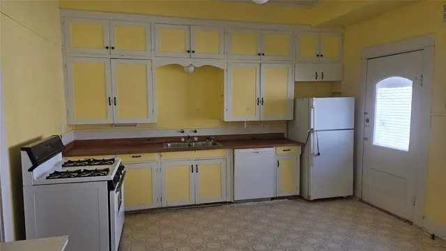 a kitchen with stainless steel appliances granite countertop a refrigerator and a stove