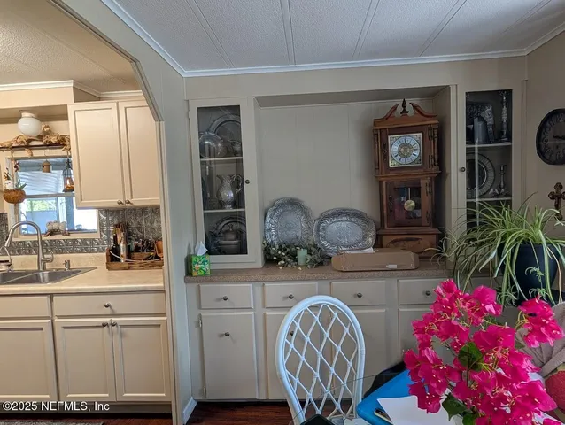 a kitchen with a white cabinets and chandelier