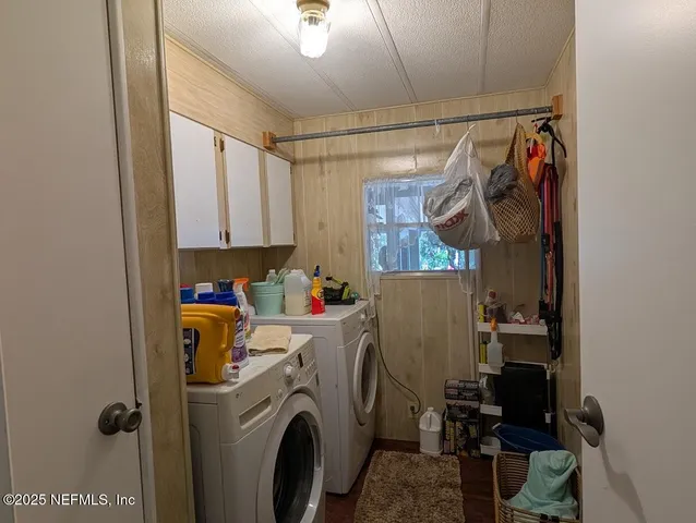 a view of storage and utility room with washer and dryer