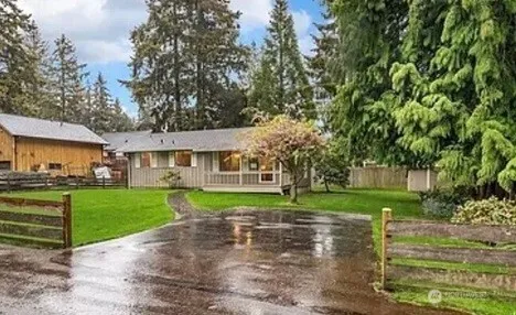 a view of a big yard next to a big yard and large trees