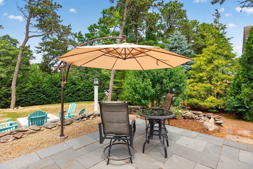 50 Pine Ridge Road Chatham, MA 02633 - Photo 33 of 42 a patio with a patio table and chairs