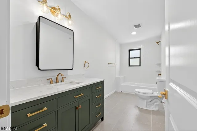 a bathroom with a bathtub and a toilet