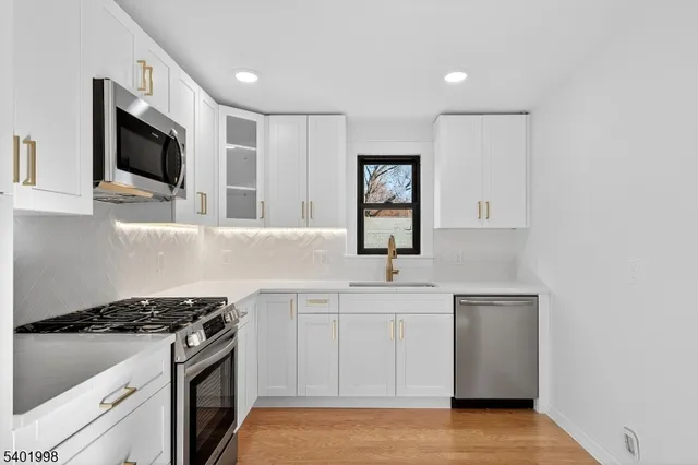 a kitchen with stainless steel appliances a sink dishwasher stove and microwave