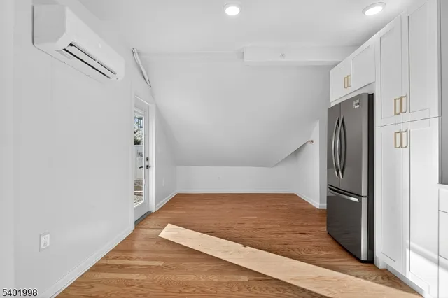 a kitchen with granite countertop a refrigerator and a sink