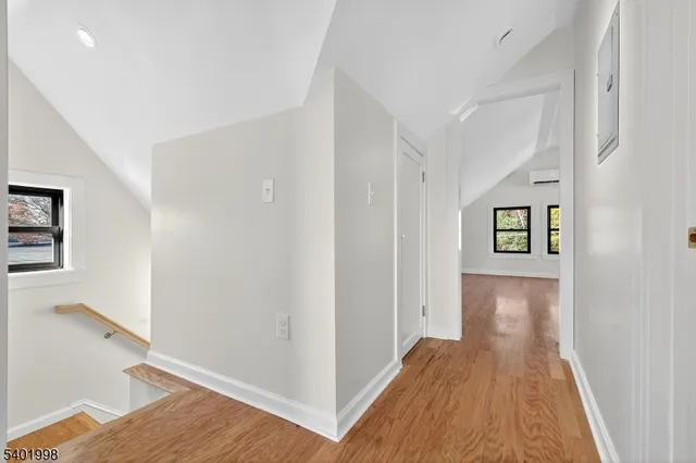 a view of hallway with wooden floor