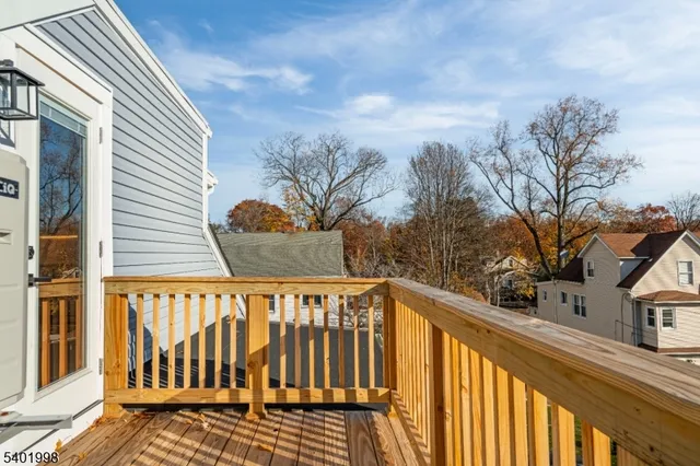 a view of a roof deck with wooden fence and floor