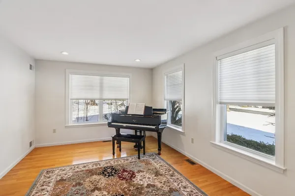 a view of a workspace with furniture and a window