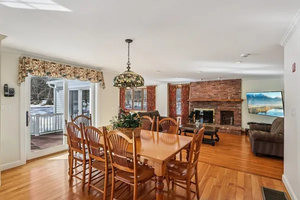 a view of a dining room with furniture wooden floor and chandelier