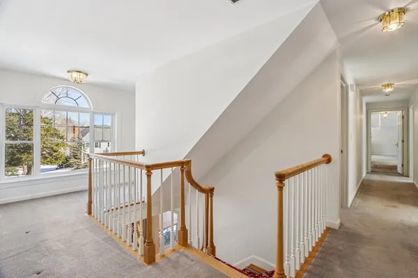 a view of a hallway with a window and stairs