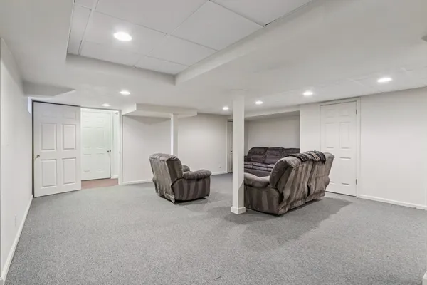 a living room with furniture a couch and kitchen view