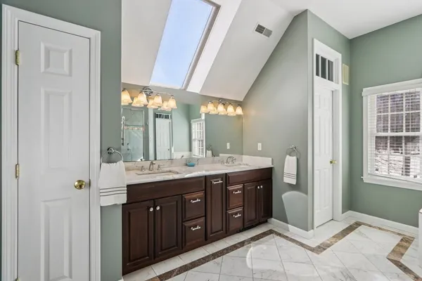 a spacious bathroom with a granite countertop sink mirror and double