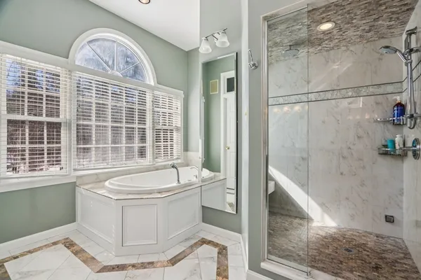 a bathroom with a sink a bathtub and shower