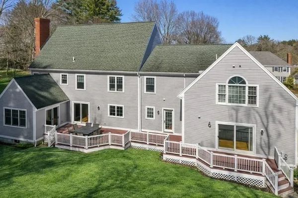 a view of a house with a yard and sitting area