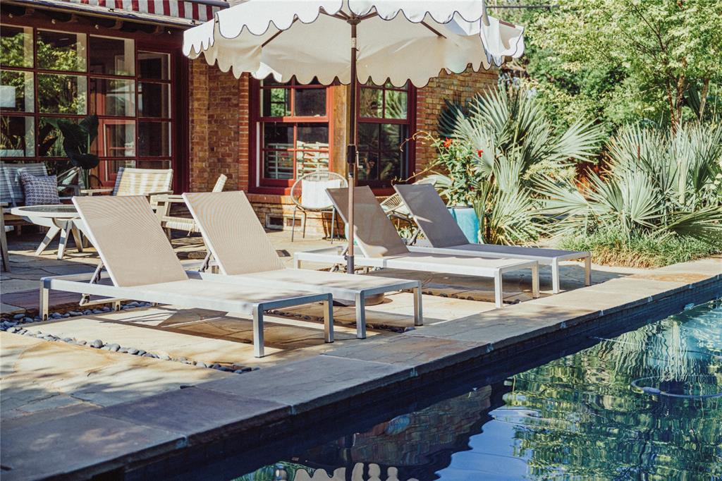 a view of a balcony with chairs and wooden floor