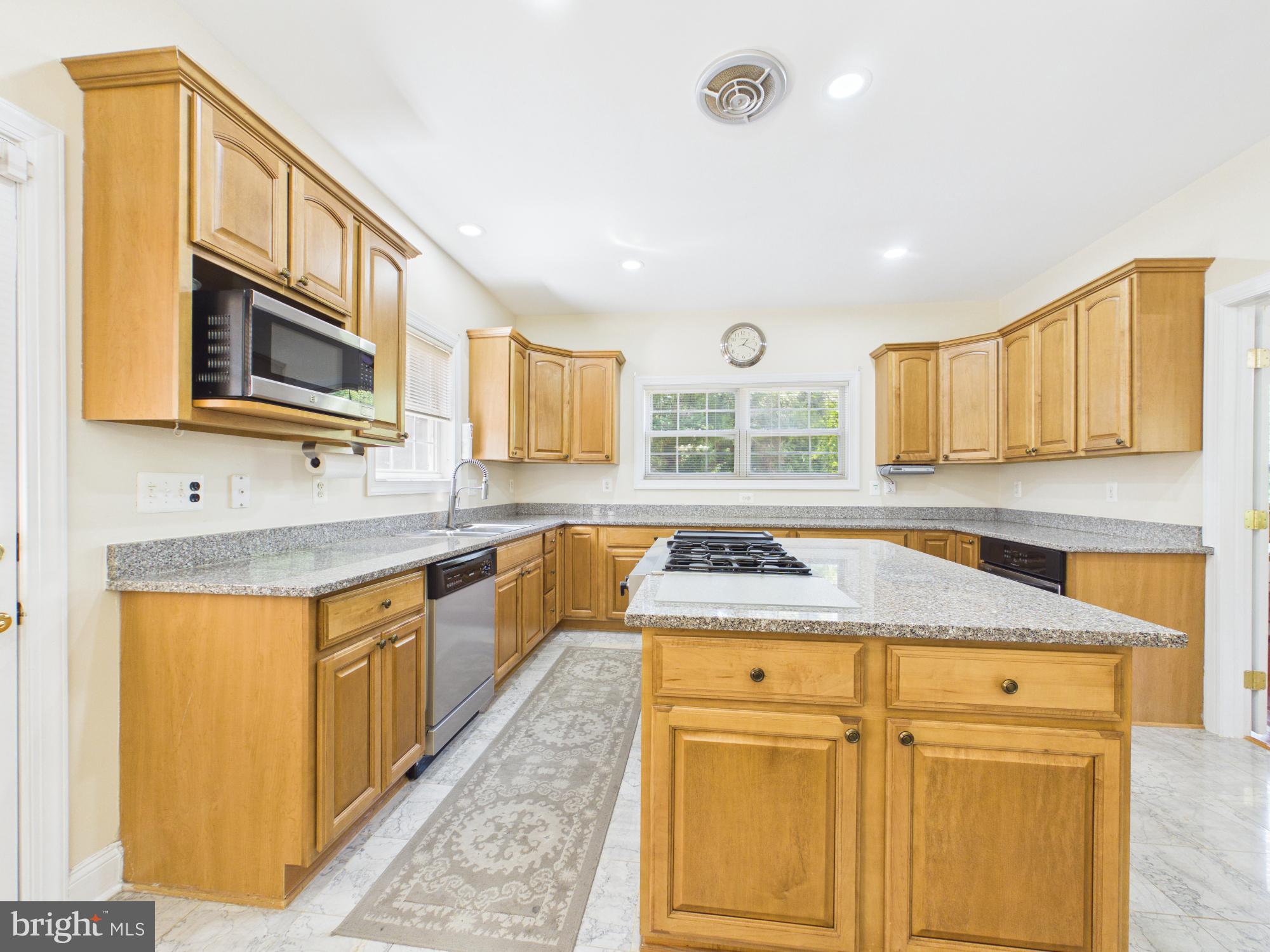 7801 Ridgewood Drive Annandale, VA 22003 - Photo 13 of 72 a kitchen with stainless steel appliances granite countertop a sink and cabinets