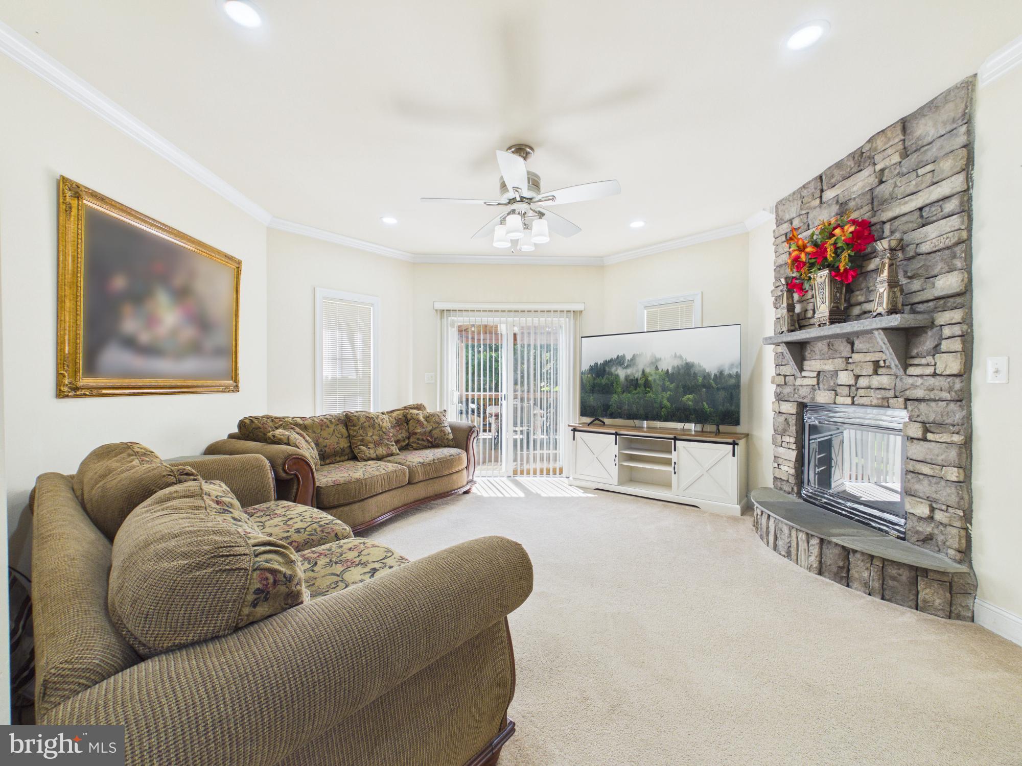 7801 Ridgewood Drive Annandale, VA 22003 - Photo 20 of 72 a living room with furniture a flat screen tv and a fireplace