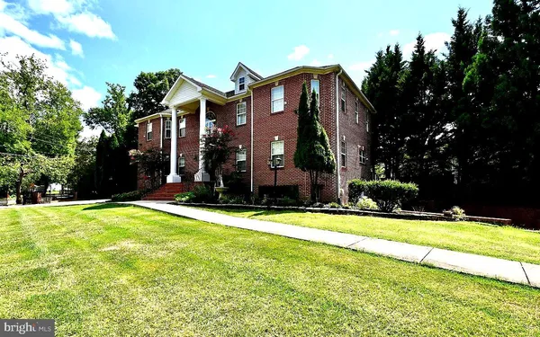 a view of a house with a swimming pool and a yard